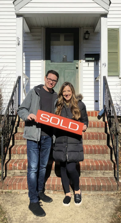 The Herrera family holding a SOLD sign at unit number four, Morristown