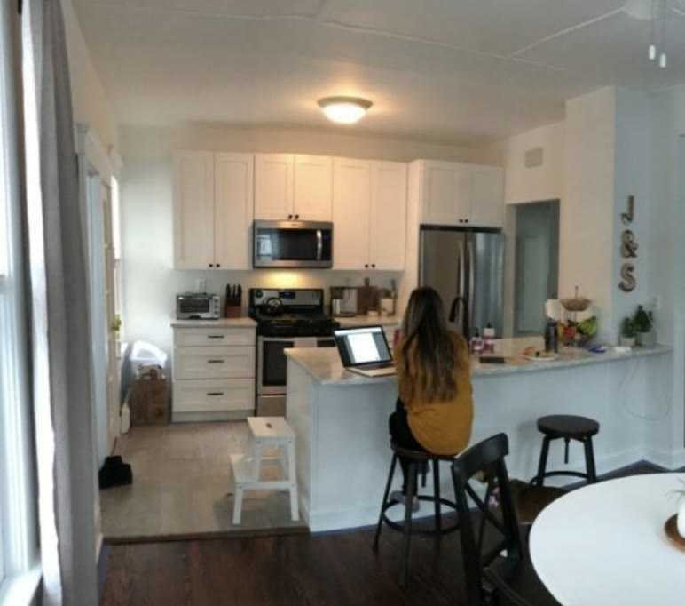 The finished Western Ave kitchen after the renovation, Steph at the counter