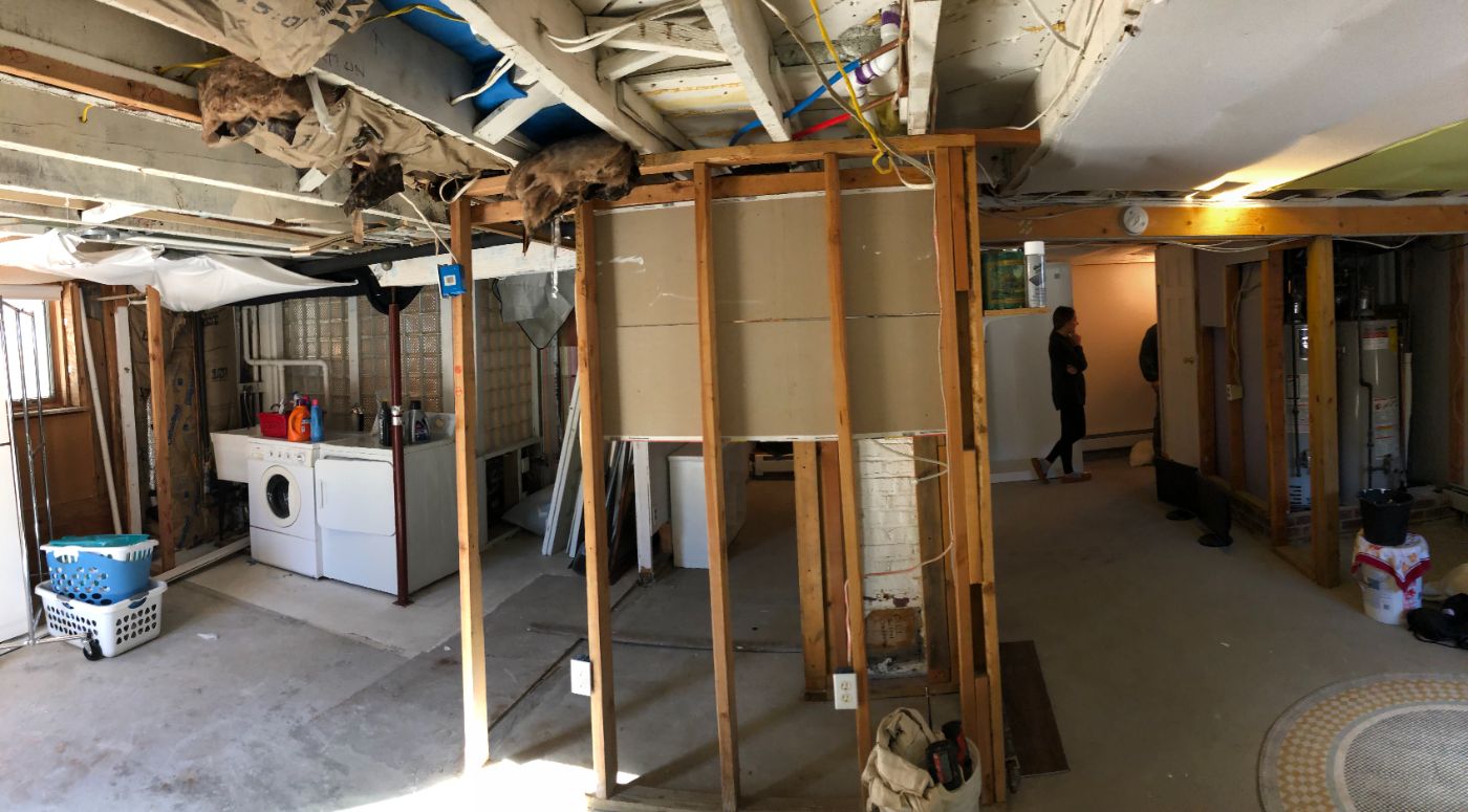The lower level down to studs and joists, laundry still in place.