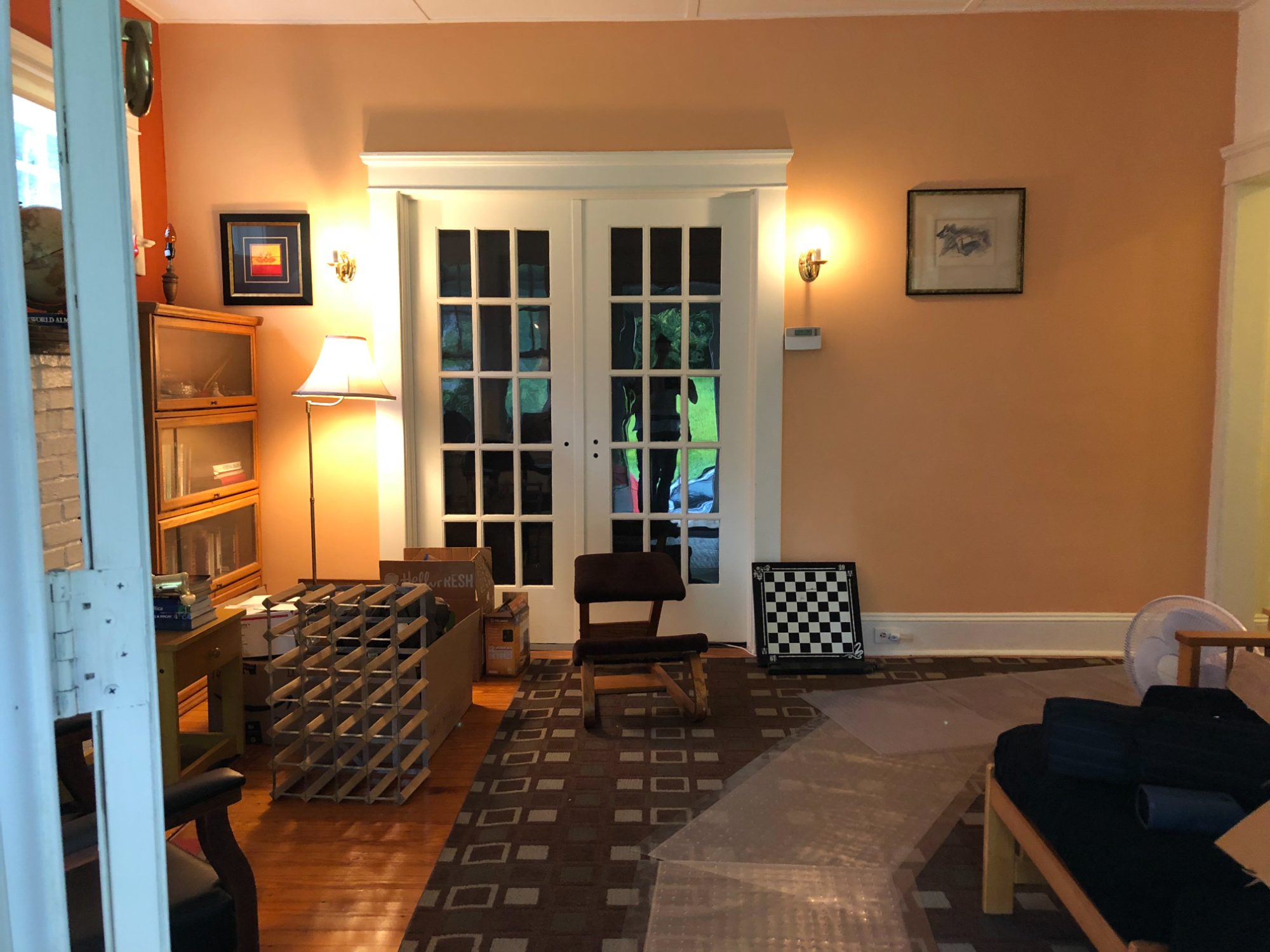The front rooms as bought: orange walls, French doors, somebody else's furniture.